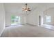 Open-concept living room with vaulted ceilings, ceiling fan, and sliding glass door to the backyard at 206 Barnwell St, Summerville, SC 29483
