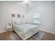 Bright bedroom features a bed with a seashell-patterned comforter, a nightstand, and a window at 2177 Gulf Dr, Mount Pleasant, SC 29464