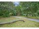 View of the charming exterior with mature trees and lush greenery around the property at 2177 Gulf Dr, Mount Pleasant, SC 29464