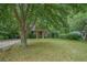 Charming home with a front yard framed by a mature tree and lush greenery at 2177 Gulf Dr, Mount Pleasant, SC 29464