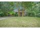 Quaint home with a well-manicured lawn, complemented by lush trees and shrubbery at 2177 Gulf Dr, Mount Pleasant, SC 29464