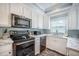 This kitchen has stainless steel appliances, white cabinets, marble countertops, and mosaic tile backsplash at 2177 Gulf Dr, Mount Pleasant, SC 29464