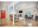 Open-concept living space featuring a fireplace, dining area, and hardwood floors at 2177 Gulf Dr, Mount Pleasant, SC 29464