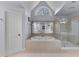 Bathroom featuring soaking tub, glass-enclosed shower, large mirror and stylish tile floors at 2221 Black Oak Ct, Mount Pleasant, SC 29466