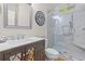 A modern bathroom offers a frameless glass shower, with elegant tile, a sink, and a decorative mirror at 2221 Black Oak Ct, Mount Pleasant, SC 29466