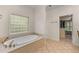 Bathroom featuring a soaking tub with marble accents, a tile floor, a shower, and a walk in closet at 2221 Black Oak Ct, Mount Pleasant, SC 29466