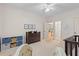 A bright bedroom with neutral carpet features three framed pictures, a ceiling fan, and a baby announcement at 2221 Black Oak Ct, Mount Pleasant, SC 29466
