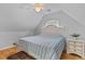 Upstairs bedroom with sloped ceilings, features a cozy bed and a ceiling fan for comfort and great natural light at 2221 Black Oak Ct, Mount Pleasant, SC 29466