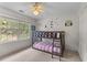 A cozy bedroom features a bunk bed, neutral carpeting, and a ceiling fan, bathed in natural light at 2221 Black Oak Ct, Mount Pleasant, SC 29466