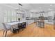 Sunlit kitchen and dining area with white cabinetry, stainless steel appliances, and hardwood flooring at 2221 Black Oak Ct, Mount Pleasant, SC 29466