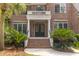 Elegant brick home entrance with stately columns and lush landscaping, leading to a welcoming front door at 2221 Black Oak Ct, Mount Pleasant, SC 29466