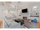 Bright living room with a fireplace, built-in shelving, and an open staircase under a high ceiling at 2221 Black Oak Ct, Mount Pleasant, SC 29466