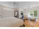 Spacious main bedroom with ceiling fans, large windows and sitting area with sofa and ottoman at 2221 Black Oak Ct, Mount Pleasant, SC 29466