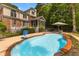 Stunning pool area with basketball hoop, lounge chairs and view of the two-story brick home at 2221 Black Oak Ct, Mount Pleasant, SC 29466
