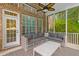 Comfortable screened porch with brick accents, ceiling fan, and a large cushioned sofa at 2221 Black Oak Ct, Mount Pleasant, SC 29466