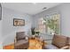 An inviting sitting area offers two leather chairs, hardwood floors, and a sunny window at 2221 Black Oak Ct, Mount Pleasant, SC 29466