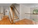 Open staircase with carpeted steps and wood railing connects the home's floors, brightened by a window at 2221 Black Oak Ct, Mount Pleasant, SC 29466