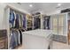 Large walk-in closet with custom shelving, built-in drawers, a window for natural light, and ample storage space at 2221 Black Oak Ct, Mount Pleasant, SC 29466