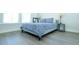 Bedroom featuring wood flooring, a blue patterned duvet, lamps, and a mirror at 232 Ashworth Dr, Summerville, SC 29486