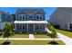 Charming two-story home features a landscaped yard, a welcoming front porch and a light blue front door at 232 Ashworth Dr, Summerville, SC 29486