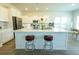 Kitchen features a white quartz island with two stools and white cabinets at 232 Ashworth Dr, Summerville, SC 29486