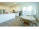 Bright kitchen with quartz countertops, white cabinets, and a dining area with chairs at 232 Ashworth Dr, Summerville, SC 29486