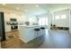 Bright kitchen with a large white island, stainless steel appliances, and hardwood flooring at 232 Ashworth Dr, Summerville, SC 29486
