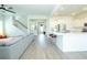 Open-concept living space with gray sofa, white kitchen, and hardwood floors at 232 Ashworth Dr, Summerville, SC 29486