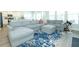 Bright living room features large gray sofa, ottoman, and patterned blue rug at 232 Ashworth Dr, Summerville, SC 29486