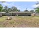Large backyard with a fire pit and trees, perfect for outdoor enjoyment at 242 Amy Dr, Goose Creek, SC 29445