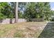 Spacious backyard with mature trees, fire pit, and privacy fence at 242 Amy Dr, Goose Creek, SC 29445