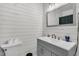 Charming bathroom with shiplap walls, modern vanity, and a well-lit mirror for a clean aesthetic at 242 Amy Dr, Goose Creek, SC 29445