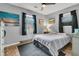 Bedroom features a ceiling fan, windows, and artwork on the walls at 242 Amy Dr, Goose Creek, SC 29445