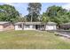 Charming single-story home with well-maintained lawn and two palm trees, ideal for a relaxed coastal lifestyle at 242 Amy Dr, Goose Creek, SC 29445