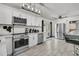 Bright kitchen with stainless steel appliances, white cabinetry, and tile floors leading to an outdoor space at 242 Amy Dr, Goose Creek, SC 29445