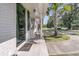 Inviting entryway with a 'Hello' mat, exterior lights, and dark-trimmed windows creating a warm, welcoming facade at 242 Amy Dr, Goose Creek, SC 29445