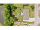 Aerial view of the residence showcasing the backyard, lush trees, nearby roads, and a pond at 264 Columbia Dr, Ladson, SC 29456