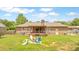 Brick home featuring a spacious backyard with a cozy fire pit and a covered deck, perfect for outdoor entertaining at 264 Columbia Dr, Ladson, SC 29456
