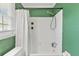 Bright green bathroom featuring a shower and tub combo with a white curtain for privacy and cleanliness at 264 Columbia Dr, Ladson, SC 29456
