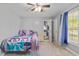 Cozy bedroom featuring a ceiling fan, comfortable carpet, and an adjacent bathroom for added convenience at 264 Columbia Dr, Ladson, SC 29456