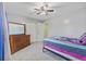 Bedroom boasting neutral gray walls, carpeting, ceiling fan, and a wooden dresser with a large mirror at 264 Columbia Dr, Ladson, SC 29456