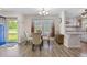 Bright dining area featuring hardwood floors, a chandelier, and adjacent kitchen at 264 Columbia Dr, Ladson, SC 29456