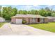 Charming brick home with a well-maintained lawn, long driveway, and a detached garage at 264 Columbia Dr, Ladson, SC 29456