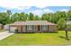 Charming single-story brick home with blue shutters, attached garage, and a well-manicured lawn at 264 Columbia Dr, Ladson, SC 29456
