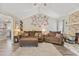 Inviting living room with vaulted ceilings, stone fireplace, and comfortable brown sofa seating at 264 Columbia Dr, Ladson, SC 29456