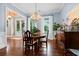 Bright dining room with hardwood floors, chandelier, and large windows with curtains at 2792 River Vista Way, Mount Pleasant, SC 29466