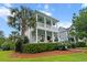 Beautiful two-story home with double porches, white columns, blue ceilings, and lush landscaping at 2792 River Vista Way, Mount Pleasant, SC 29466