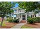 Elegant two-story home featuring double porches, grand columns, and meticulously landscaped front yard at 2792 River Vista Way, Mount Pleasant, SC 29466