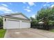 Detached two-car garage with a concrete driveway, surrounded by a black fence and lush greenery at 2792 River Vista Way, Mount Pleasant, SC 29466