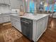 Kitchen island with white cabinets, quartz countertops, stainless steel dishwasher, and copper faucet at 2792 River Vista Way, Mount Pleasant, SC 29466